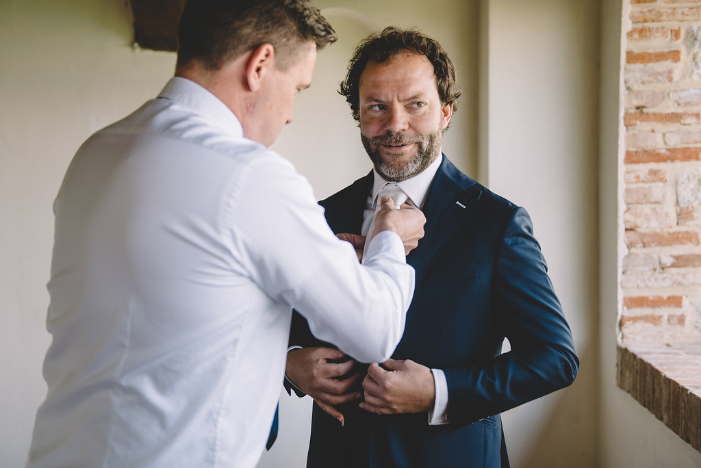 Groom is getting ready, destination wedding in Tuscan Castle di Montalto